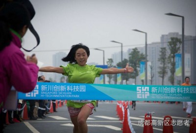 Hands raised in victory as the winner reaches the finishing line